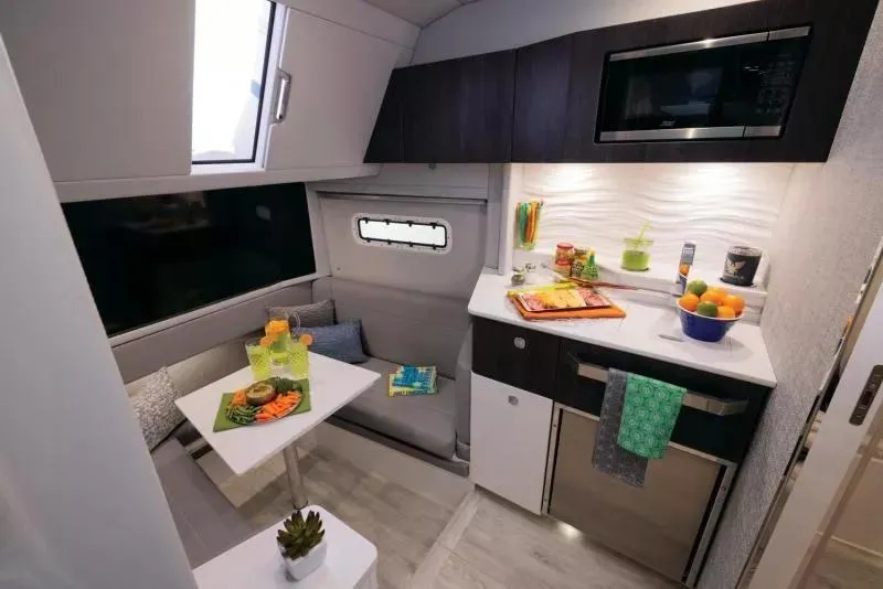 Slide: The Image of 2025 Formula 457 Center Console Sport interior with modern kitchenette and dining area. - 12