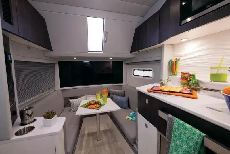 Slide: The Image of Interior of 2025 Formula 457 Center Console Sport boat with modern kitchen and seating area. - 13