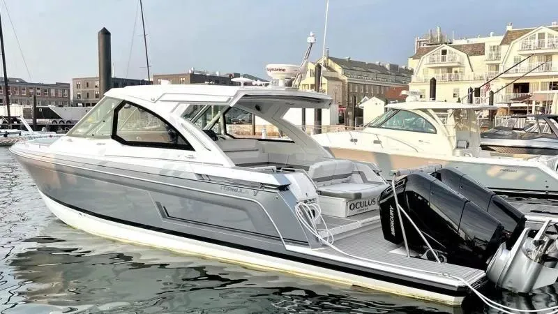 Slide: The Image of 2023 Formula 380 Super Sport Crossover OB boat docked in a marina. - 1