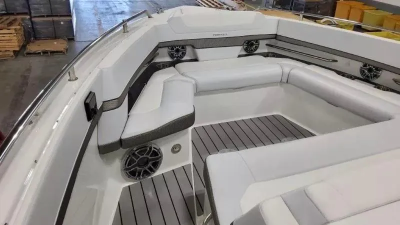 Slide: The Image of 2023 Formula 380 Super Sport Crossover OB boat interior with white seating and speakers. - 10