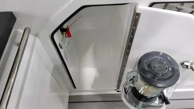 Slide: The Image of 2023 Formula 380 Super Sport Crossover OB boat interior with storage compartment and winch. - 17