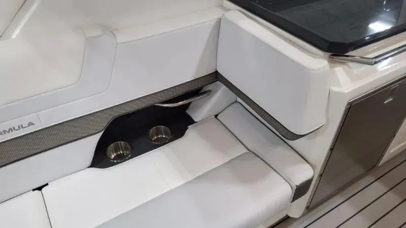 Slide: The Image of 2023 Formula 380 Super Sport Crossover OB interior with white seating and cup holders. - 19