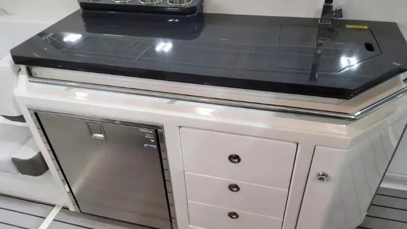 Slide: The Image of 2023 Formula 380 Super Sport Crossover OB boat interior with sleek kitchenette and storage. - 24