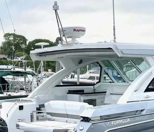 Slide: The Image of 2023 Formula 380 Super Sport Crossover OB yacht docked at marina. - 7