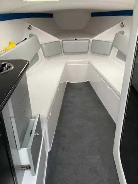 Slide: The Image of 2014 Baja 35 Outlaw cabin interior with seating and storage. - 10