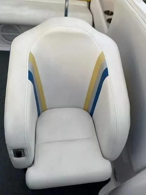 Slide: The Image of White seat with blue and yellow accents in a 2014 Baja 35 Outlaw boat. - 12
