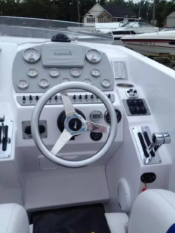Slide: The Image of 2014 Baja 35 Outlaw boat dashboard with steering wheel and gauges. - 14