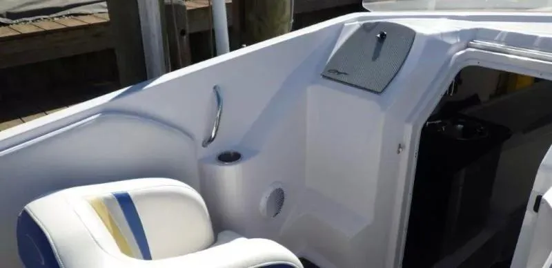 Slide: The Image of 2014 Baja 35 Outlaw boat interior with white seating and blue-yellow accents. - 16