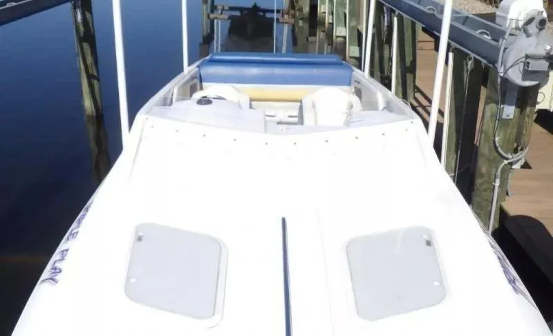 Slide: The Image of 2014 Baja 35 Outlaw boat docked at marina, top view. - 3