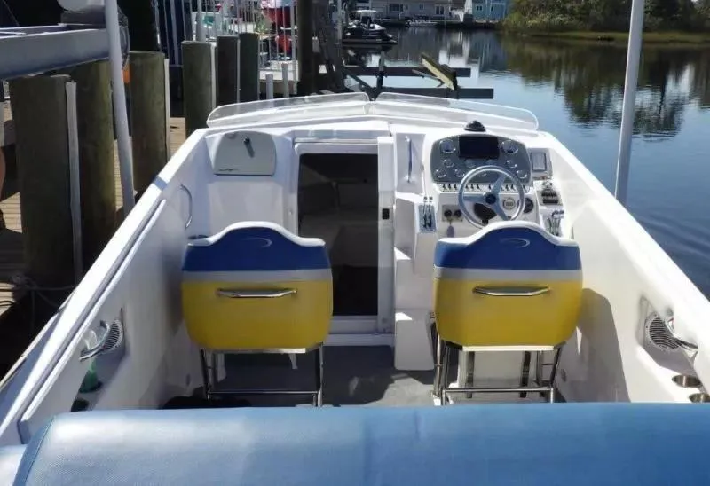 Slide: The Image of 2014 Baja 35 Outlaw boat interior with dual yellow and blue seats. - 4