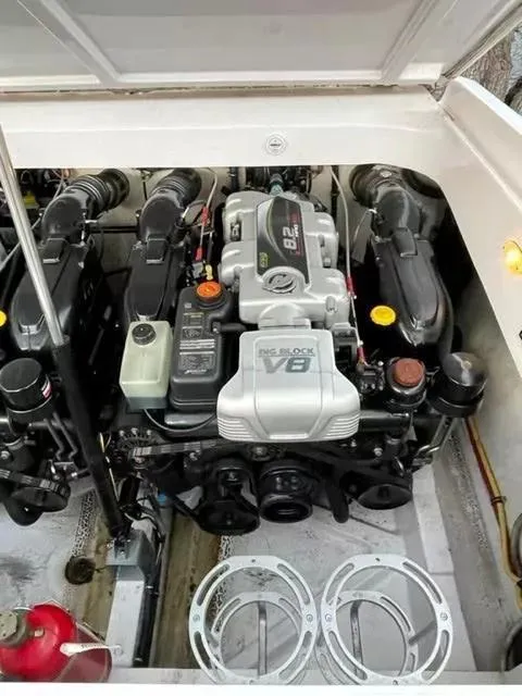 Slide: The Image of 2014 Baja 35 Outlaw engine compartment with V8 engine, showcasing powerful marine performance. - 6