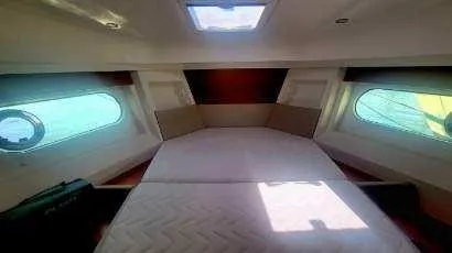 Slide: The Image of 2017 Beneteau Swift Trawler 30 cabin interior with large windows and overhead skylight. - 11