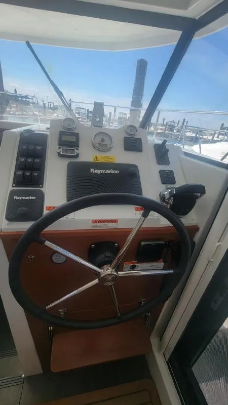 Slide: The Image of Helm of 2017 Beneteau Swift Trawler 30 with Raymarine navigation system. - 13