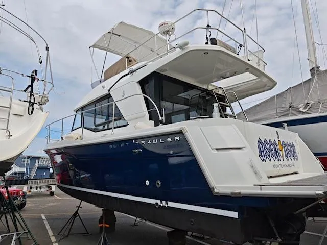 Slide: The Image of 2017 Beneteau Swift Trawler 30 in dry dock, showcasing sleek design and modern features. - 18