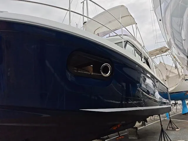 Slide: The Image of 2017 Beneteau Swift Trawler 30, blue hull, docked in a marina. - 19