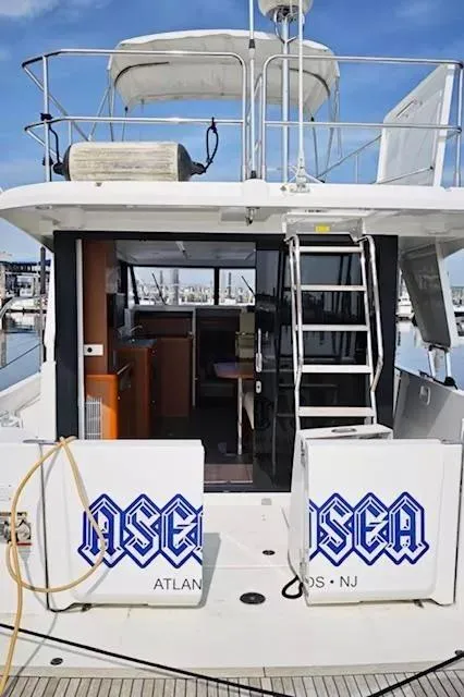 Slide: The Image of 2017 Beneteau Swift Trawler 30, rear view, docked, with open cabin and ladder access. - 22