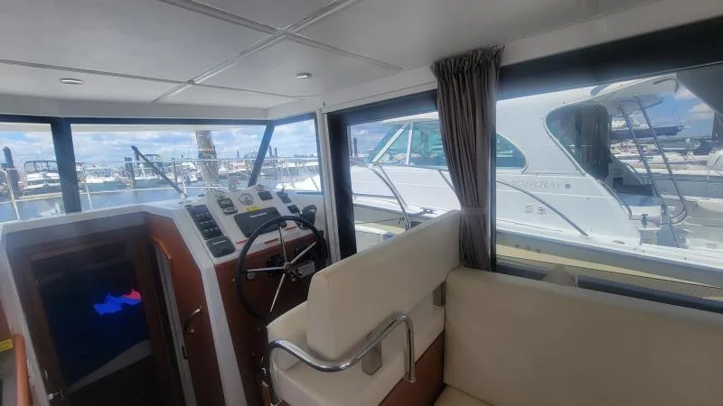 Slide: The Image of Interior view of a 2017 Beneteau Swift Trawler 30, showcasing helm and seating area. - 9