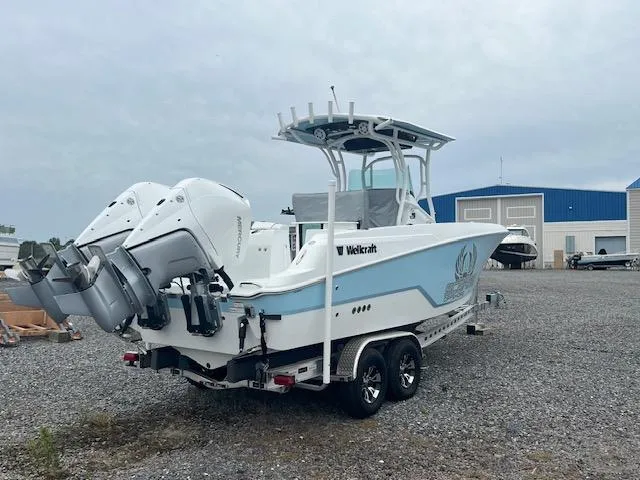 Slide: The Image of 2022 Wellcraft 262 Fisherman boat on trailer, dual engines, parked outdoors. - 4