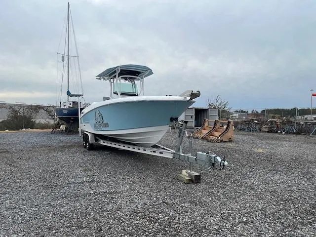 Slide: The Image of 2022 Wellcraft 262 Fisherman boat on trailer in gravel lot, overcast sky. - 5