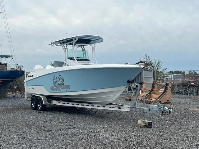Slide: The Image of 2022 Wellcraft 262 Fisherman boat on trailer, parked on gravel lot under cloudy sky. - 8