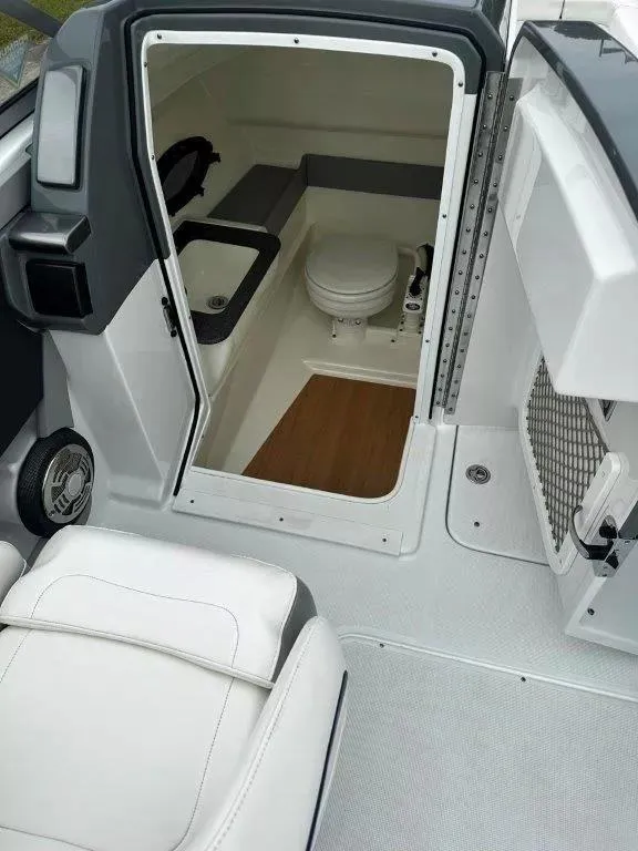 Slide: The Image of 2013 Formula 270 Bowrider boat interior with compact bathroom and seating area. - 10