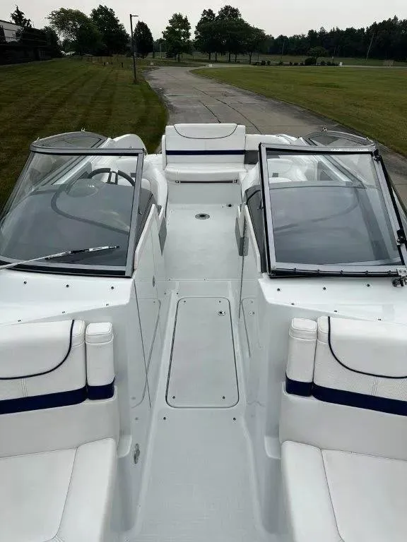 Slide: The Image of 2013 Formula 270 Bowrider boat interior with white seating and dual windshields. - 12