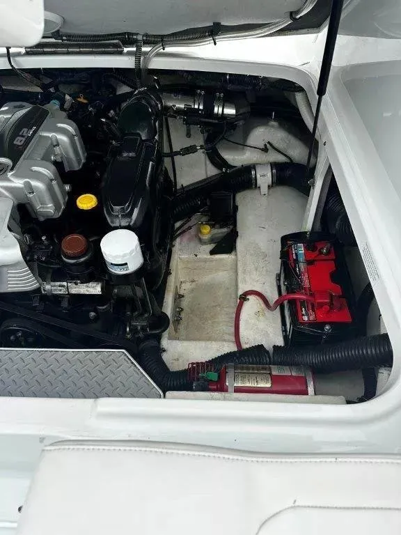 Slide: The Image of Engine compartment of a 2013 Formula 270 Bowrider with visible battery and components. - 16