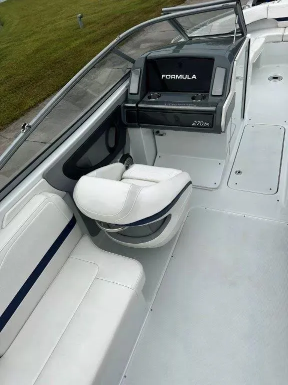 Slide: The Image of 2013 Formula 270 Bowrider boat interior with white seating and dashboard. - 9