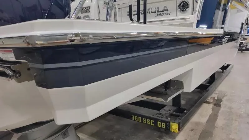 Slide: The Image of 2024 Formula 380 Super Sport Crossover OB boat, side view in a showroom. - 10