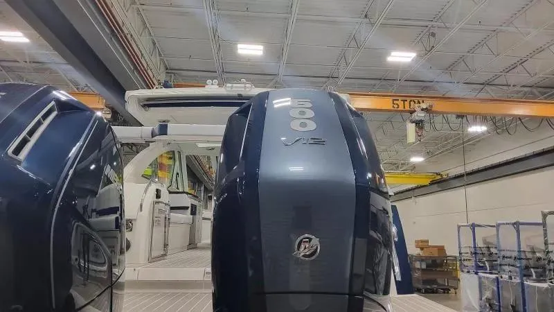 Slide: The Image of 2024 Formula 380 Super Sport Crossover OB with powerful V12 engines in a spacious indoor facility. - 13