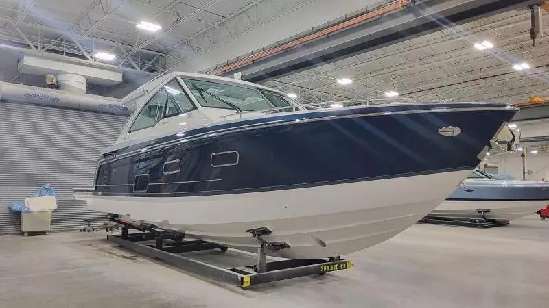 Slide: The Image of 2024 Formula 380 Super Sport Crossover OB boat in a showroom, side view. - 2