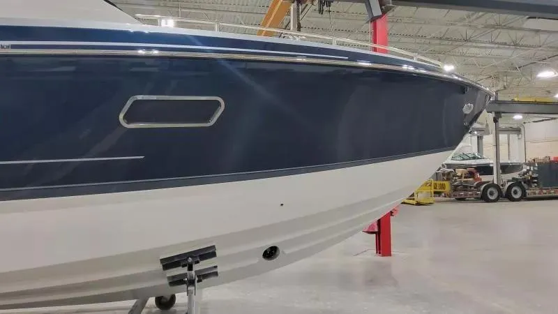 Slide: The Image of 2024 Formula 380 Super Sport Crossover OB boat in a showroom, side view. - 3