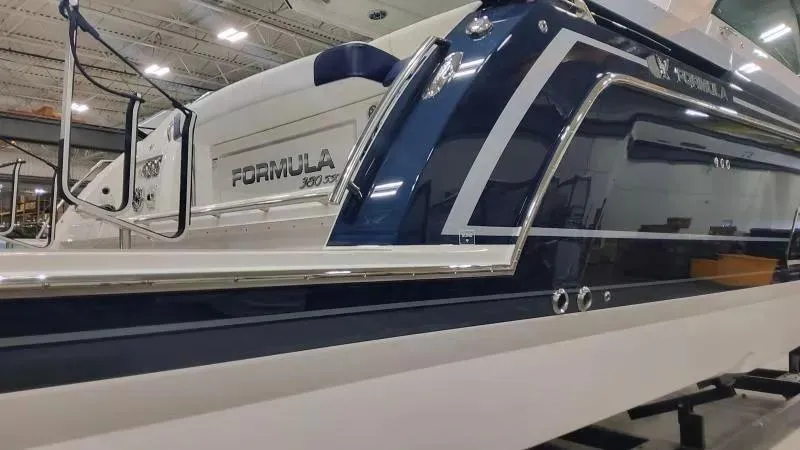 Slide: The Image of 2024 Formula 380 Super Sport Crossover OB boat in showroom, showcasing sleek design and branding. - 5