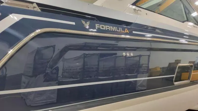 Slide: The Image of 2024 Formula 380 Super Sport Crossover OB boat, sleek blue exterior with chrome accents. - 7