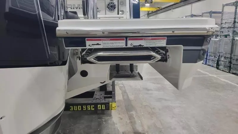 Slide: The Image of 2024 Formula 380 Super Sport Crossover OB boat stern in a workshop setting. - 9