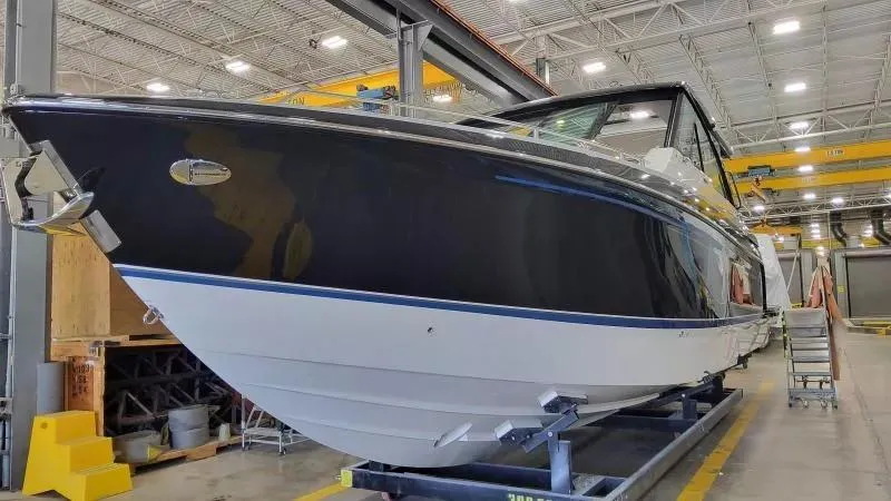 Slide: The Image of 2025 Formula 380 Super Sport Crossover OB in a boatyard, showcasing sleek design and modern features. - 1