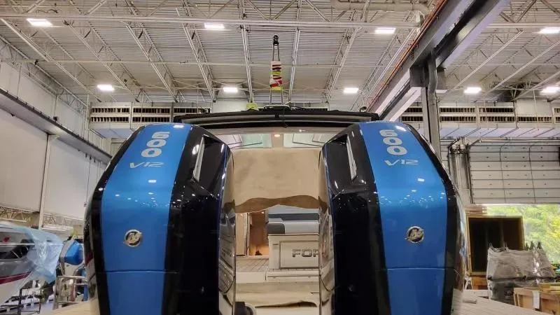 Slide: The Image of 2025 Formula 380 Super Sport Crossover OB with twin 600 V12 engines in a warehouse. - 13