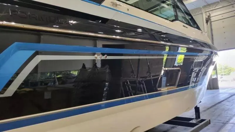 Slide: The Image of 2025 Formula 380 Super Sport Crossover OB boat in a showroom, showcasing sleek design. - 4