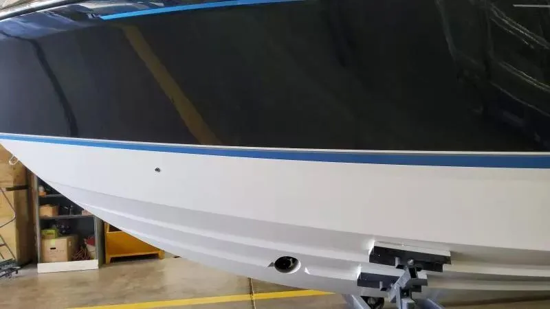 Slide: The Image of 2025 Formula 380 Super Sport Crossover OB boat hull in a showroom. - 5