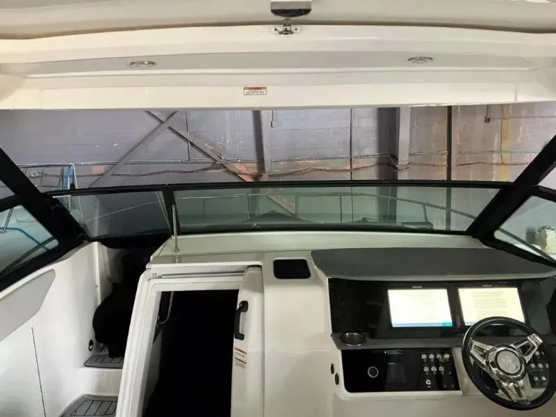 Slide: The Image of 2020 Sea Ray Sundancer 320 OB helm with dual displays and steering wheel. - 11