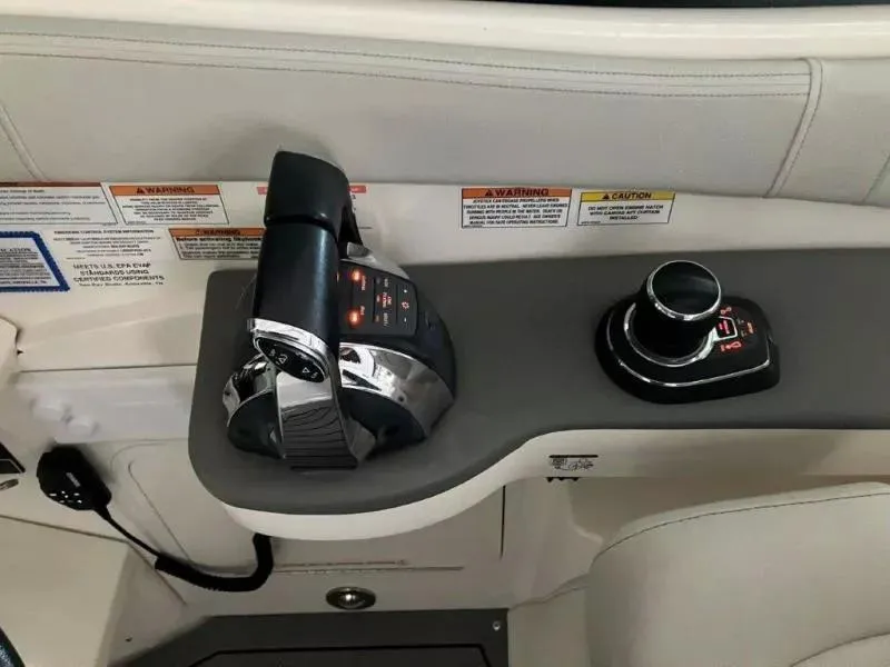 Slide: The Image of 2020 Sea Ray Sundancer 320 OB helm controls with throttle and joystick. - 13