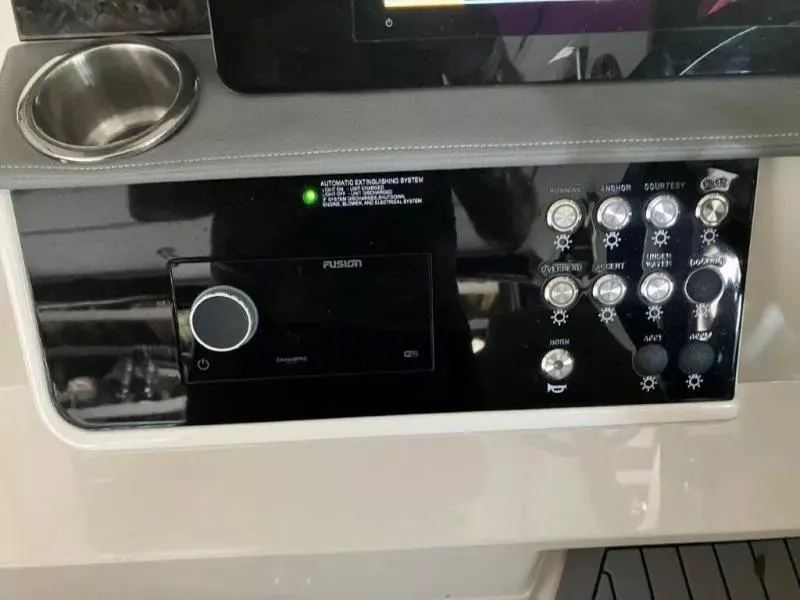 Slide: The Image of Control panel of a 2020 Sea Ray Sundancer 320 OB boat with various buttons and a Fusion stereo. - 15