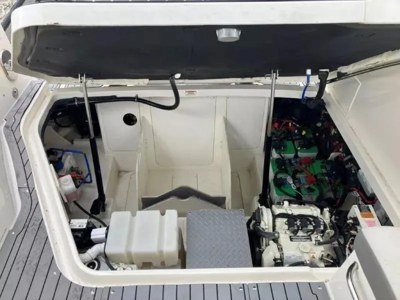 Slide: The Image of 2020 Sea Ray Sundancer 320 OB engine compartment, showcasing mechanical components and storage space. - 21