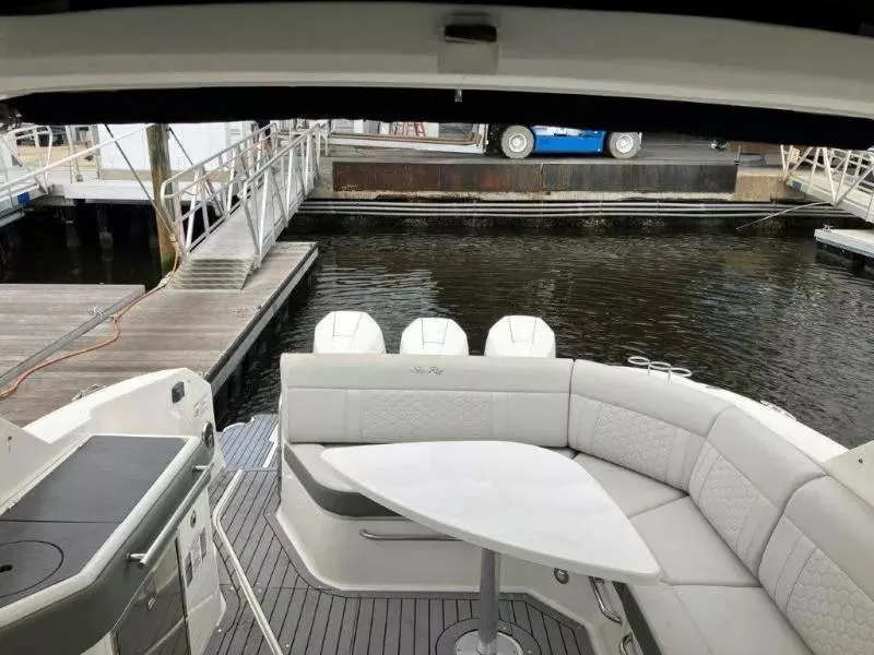 Slide: The Image of 2020 Sea Ray Sundancer 320 OB with elegant seating and table, docked at marina. - 23