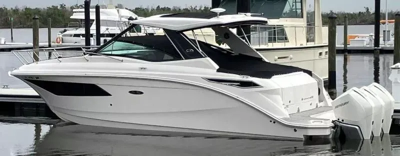 Slide: The Image of 2020 Sea Ray Sundancer 320 OB boat docked at marina, side view. - 4