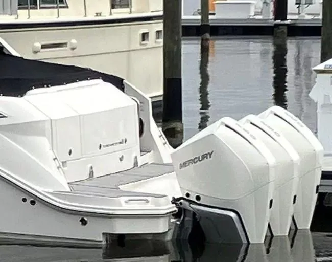 Slide: The Image of 2020 Sea Ray Sundancer 320 OB with triple Mercury outboard engines docked in marina. - 6