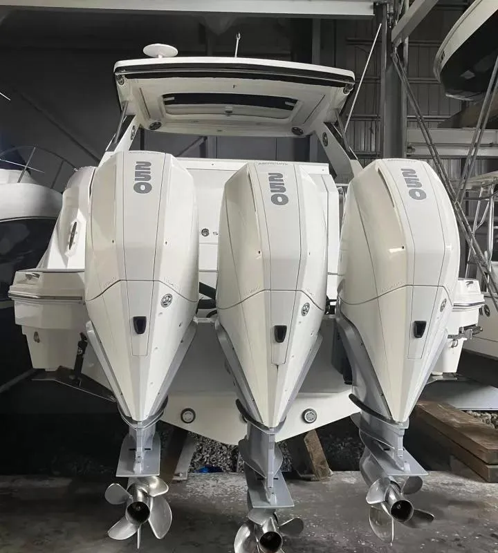 Slide: The Image of 2020 Sea Ray Sundancer 320 OB with triple outboard engines in a marina. - 7