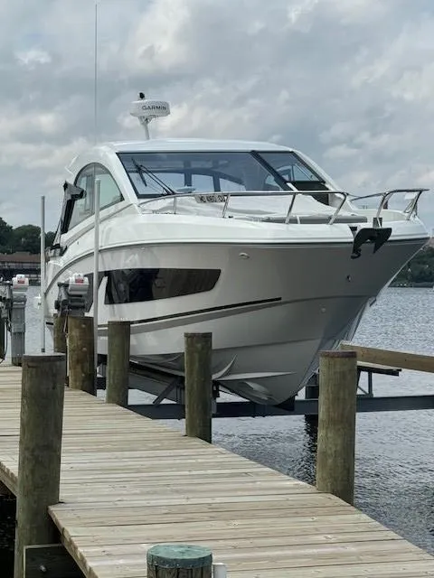 Slide: The Image of 2024 Beneteau Gran Turismo 32 yacht docked by a wooden pier. - 1