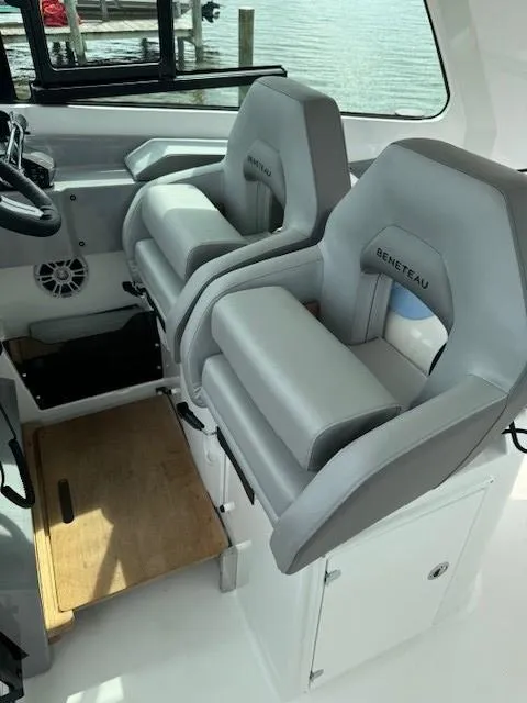 Slide: The Image of 2024 Beneteau Gran Turismo 32 cockpit with dual gray seats and steering wheel. - 15
