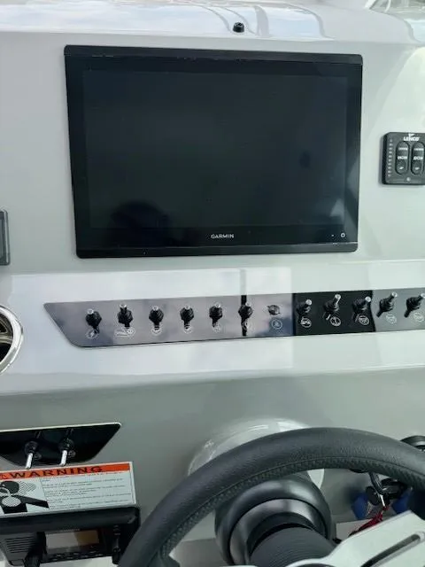 Slide: The Image of 2024 Beneteau Gran Turismo 32 dashboard with Garmin display and control switches. - 23